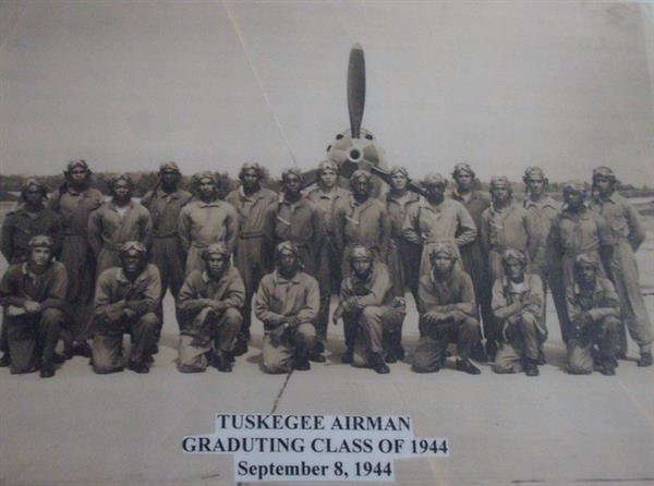 Tuskegee Airmen Graduating Class of 1944 group photo in front of a plane